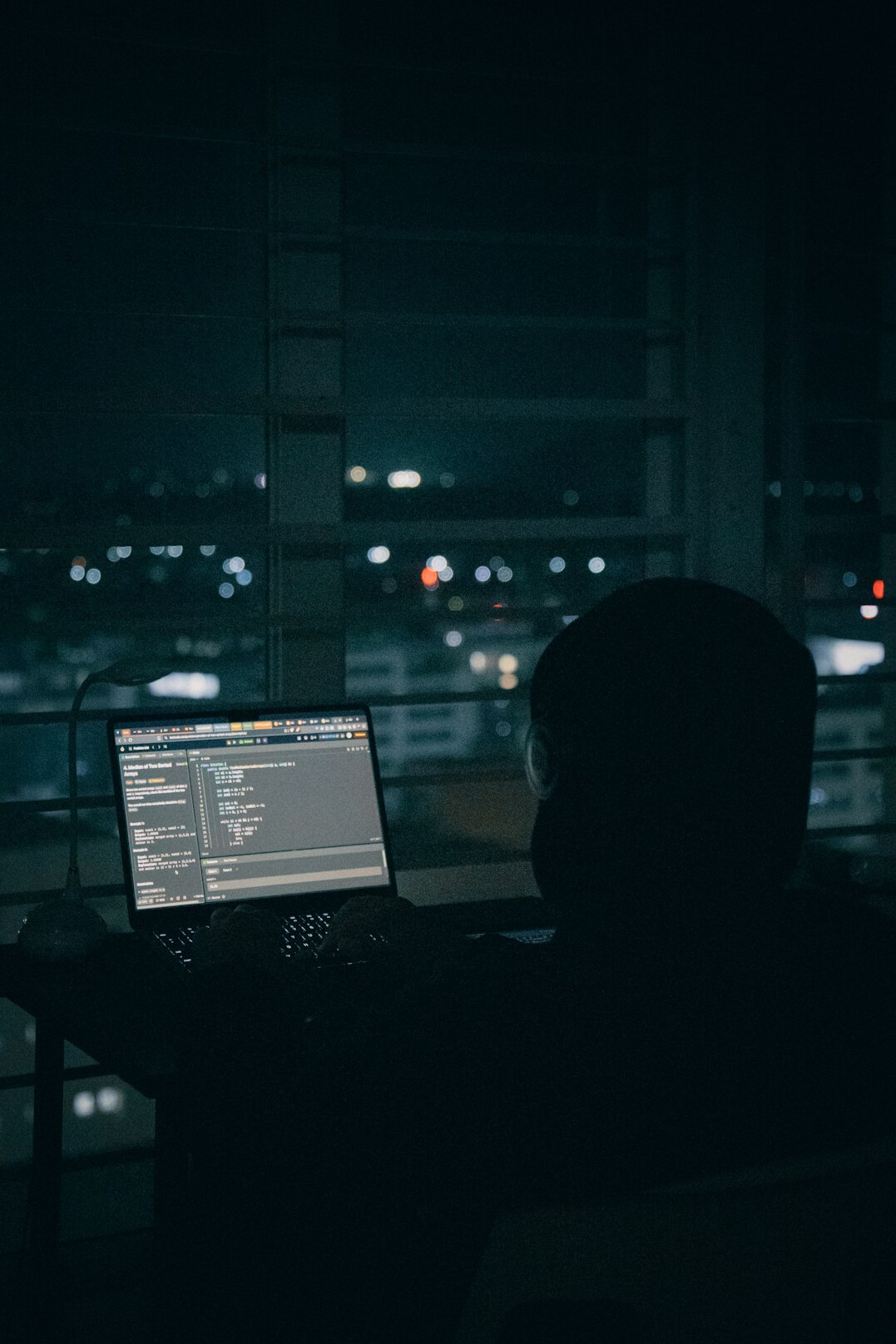 detective using laptop at night